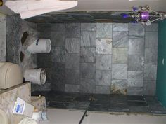 a bathroom with a toilet, sink and shower stall in the middle of it is being remodeled