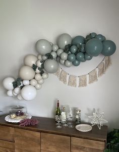 balloons are hanging on the wall above a dresser