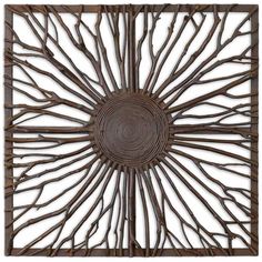 a metal wall sculpture with branches in the shape of a sunburst on a white background