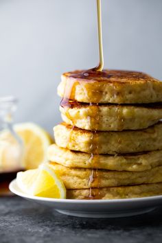 a stack of pancakes with syrup being drizzled on top