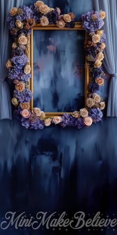 an ornate gold frame with purple flowers on it in front of a blue curtained window