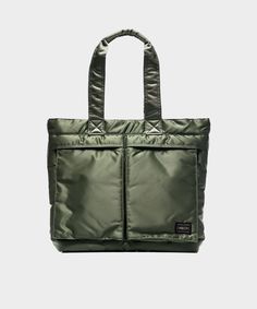 Made from military-grade fabric, this little tote is tough, but tailored: the 3-layer construction and durable nylon exterior will hold up to whatever you throw at them, while careful detailing and an olive hue keep things sleek. It features two handles, a zip-top closure, and two front pockets — perfect for running out to the store, running to work, and generally running around town. This bag is part of our Okura Capsule. Okura means “warehouse” in Japanese, and this collection reflects Todd’s Porter Bag, Indigo Dyed Fabric, Porter Yoshida, The Right Stuff, Nylon Tote Bags, Designer Totes, Nylon Tote, Military Inspired, Nylon Bag