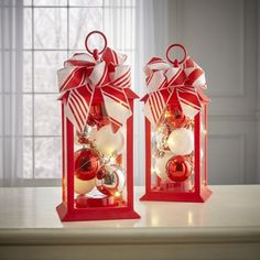 two red lanterns decorated with ornaments and bows