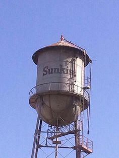 an old water tower with the sunfit logo on it