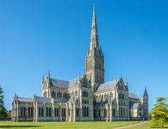 a large cathedral with many spires on it's sides and trees in the foreground