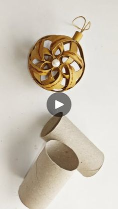 a roll of toilet paper sitting on top of a white counter next to a golden object