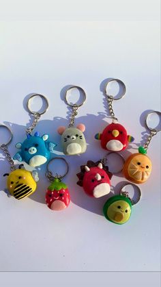 several key chains with different types of cartoon characters attached to them, sitting on a white surface