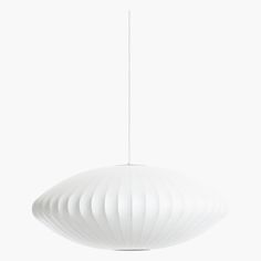 a large white light hanging from a ceiling