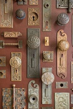 an assortment of door knobs and locks on a wall