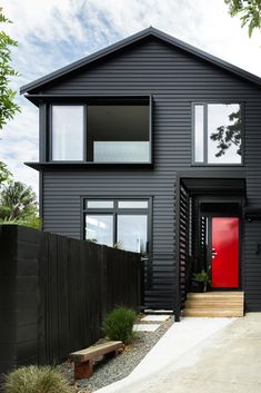 a black house with red door and windows