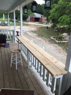 a wooden bench sitting on top of a porch