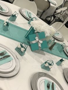 the table is set with blue and white place settings