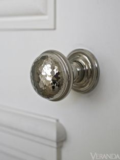 a close up of a knob on a white door