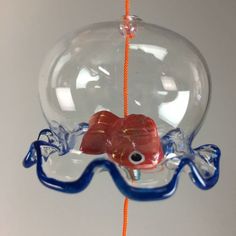 an ornament shaped like a fish hanging from a string