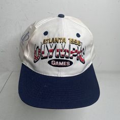 Vintage Atlanta 1996 Olympic Games Hat 90s White Blue Cap Nwt Read. New With Tags However Has A Bunch Of Stains Throughout. Sold Exactly As Pictured. Retro White Baseball Cap For Sports Events, Retro White Hats For Sports Events, White Vintage Snapback Hat For Sports, Vintage White Baseball Cap For Sports, Retro White Hat For Sports Events, Vintage White Baseball Cap, Vintage White Sports Hat, Vintage White Trucker Hat For Sports, Vintage White Trucker Hat For Sports Events