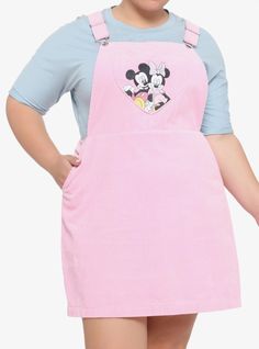 a woman wearing an apron with mickey mouse on the front and minnie mouse on the back