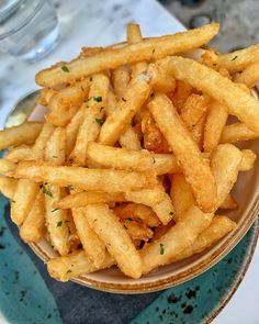 french fries in a bowl on a table