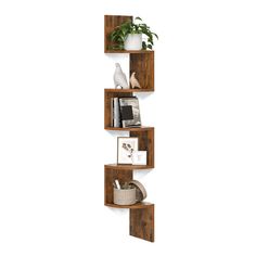 three wooden shelves with plants and pictures on them, one is leaning against the wall