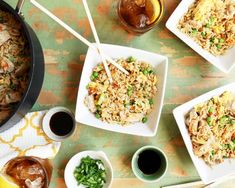 several plates of food on a table with chopsticks in them and drinks nearby