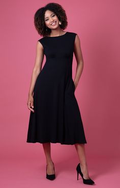 Feel utterly demure in the simplest, chicest and most flattering LBD of the season. In a class of its own, say hello to the Luna Midi in pure black. Feel neatly polished in a style with smooth lines, high neckline and nipped in empire waist. A swishy, playful skirt adds an element of fun, whilst the pockets are just non-negotiable. Made from sustainable Lenzing Ecovero viscose jersey which is knitted and dyed in the UK. Chic black jersey dress High neckline, nipped in empire waist, shoulder cove Sleek A-line Midi Dress With Flattering Silhouette, Black H-line Midi Dress For Formal Occasions, Classic Dresses For Work With Flattering Cut, Elegant Black H-line Dress, Classic Knee-length Midi Dress With Flattering Cut, Classic Fitted Midi Dress With Flattering Cut, Flattering Evening Midi Dress, Flattering Solid Midi Dress For Evening, Black H-line Midi Dress For Work