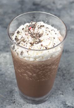 there is a drink with whipped cream and chocolate sprinkles