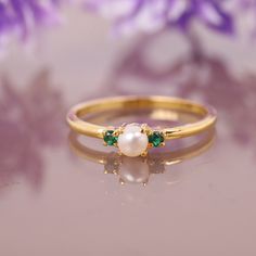 Freshwater Pearl Emerald Ring, 14K Solid Gold Ring, Engagement Ring, June birthstone, Three stone Ring, Anniversary Gift For Women's Jewelry Main Stone: Fresh Water Pearl Main Stone Color: White Main Stone Shape: Round Main Stone Size: 5mm Birthstone Month: June Second Stone: Emerald Stone Shape: Round Stone Color: Green Jewelry Type: Ring Metal: Silver Method: Cast Personalization: Possible Style: Chevron Ring Size: We make rings from US 3 to US 10. This elegant ring is perfect for any occasion Heirloom Multi-stone Pearl Ring As Gift, Heirloom Multi-stone Pearl Ring Gift, Heirloom Birthstone Ring, Gold Pearl Ring With Birthstone For Fine Jewelry, 14k Yellow Gold Pearl Ring With Birthstone, Green Opal Birthstone Ring In 14k Gold, Yellow Gold Pearl Ring With Birthstone In 14k Gold, Gold Pearl Ring With Birthstone, Yellow Gold 14k Pearl Ring With Birthstone