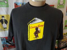 a black shirt with a yellow book on it