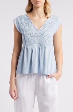 Floral embroidery rendered in tonal threads brings nearly 3D texture to the bib of this babydoll-style top cut from fresh, lightweight cotton. 22" length (size Medium) V-neck Cap sleeves 100% cotton Machine wash, tumble dry Imported Light Blue Floral Embroidered V-neck Top, Short Sleeve Cotton Top With Tonal Embroidery, Light Blue Linen Short Sleeve Top, Spring Tops With Tonal Embroidery And Short Sleeves, Short Sleeve Tops With Tonal Embroidery For Spring, Short Sleeve Cotton Embroidered Top With Tonal Embroidery, Cotton Embroidered Top With Short Sleeves, Cotton Embroidered Top With Tonal Embroidery And Short Sleeves, Tonal Embroidery Short Sleeve Tops