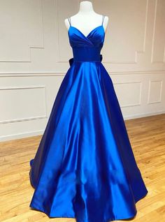 Welcoming a fusion of classic elegance and modern simplicity, this royal blue prom dress is a true showstopper. The luxurious satin fabric glistens with a lustrous sheen, ensuring that you shine under the lights of the ballroom. Its sleek bodice with a plunging neckline is both daring and demure, while the full A-line skirt adds a regal touch to your every move. A refined waistband cinches the waist, creating a flattering silhouette that celebrates the figure. This gown is not just a dress, but a statement of confidence and grace, perfect for an unforgettable prom night. Royal Blue Satin Prom Dress, Royal Blue Prom, Winter Formal Dresses, 2024 Prom, Royal Blue Prom Dresses, Spaghetti Strap Prom Dress, Marine Uniform, Floor Length Prom Dresses, Blue Evening Dresses