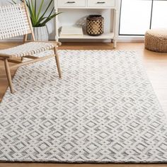 a living room with a white rug and chair