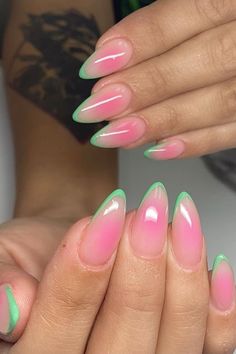 a woman's hands with pink and green nails