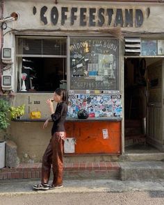 a woman standing in front of a coffee shop