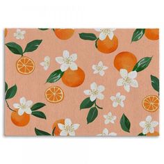 an orange and white flowered pattern on pink background with leaves, flowers, and fruit