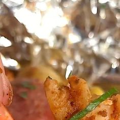 a close up of food on a plate with meat and veggies in the background