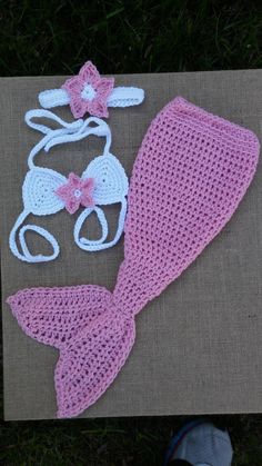 a crocheted mermaid tail, hat and diaper on a piece of cloth