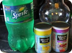 two bottles of sprite are sitting next to each other on a counter top, one is green and the other is yellow