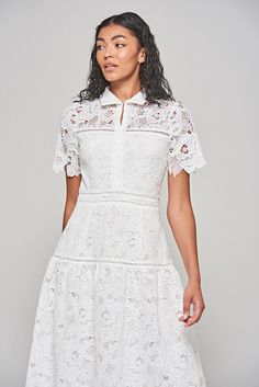 Game, set and match, this white lace dress is a guaranteed win for your summer wardrobe! A style to truly fall in love with, the mid length Kalina features a classic shirt collar and whimsical scalloping across the sleeves and hem. Daywear Mini Dress With Scalloped Lace, Elegant White Collared Dress, White Mini Dress With Lace Collar, Spring White Mini Dress With Lace Collar, White Mini Dress With Lace Collar For Spring, Fitted White Lace Dress With Lace Collar, White Fitted Lace Dress With Lace Collar, Elegant Scallop Lace Mini Dress For Daywear, Summer Lace Dress With Lace Collar And Short Sleeves