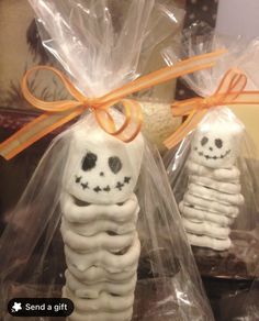 two skeleton cookies wrapped in cellophane and tied with orange ribbon