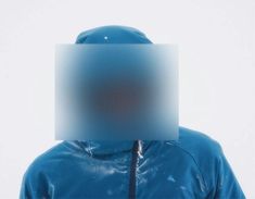 a person wearing a blue jacket with a blurry image on the back of their head