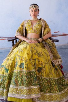 Mustard pure silk lehenga with kalamkari hand painted floral, bird motifs and aari, sequin work. Paired with embroidered, kalamkari hand painted sleeveless blouse and kalamkari dupatta.
Component: 3
Pattern: Embroidered, Hand Painted
Type Of Work: Kalamkari, Aari, Sequin
Neckline: V Neck
Sleeve Type: Sleeveless
Fabric: Pure Silk, Organza Silk
Color: Yellow
Other Details: 
Organza silk dupatta
Kalamkari, aari and sequin work
Tassel detail
Occasion: Wedding - Aza Fashions Yellow Silk Lehenga With Intricate Embroidery, Designer Meenakari Chanderi Lehenga, Navratri Meenakari Choli In Raw Silk, Raw Silk Tilla Dupatta For Reception, Transitional Yellow Dola Silk Lehenga, Bollywood Style Meenakari Saree Dress, Bollywood Saree Dress With Meenakari, Navratri Yellow Meenakari Choli, Bollywood Style Saree Dress With Meenakari