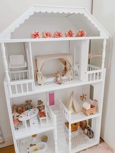 a doll house with all the furniture and accessories in it's white display case