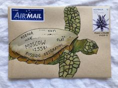 an airmail envelope with a drawing of a turtle