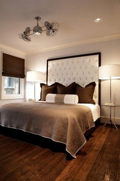 a bedroom with a large bed and two lamps on either side of the headboard