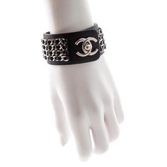 This exceptional secondhand Chanel Turnlock Bracelet is an edgy statement piece that is waiting to upgrade your luxury looks! Composed of black Italian leather, this wide cuff bracelet is adorned by four rows of tonal interwoven leather and aged silver-toned chains. An oversized CC turn-lock clasp closure sits at the center of this piece for easy access and the utmost security. From the French fashion house's Spring 2013 collection, this luxury bracelet is the ultimate collector's item that will Designer Closet, Wide Cuff Bracelets, Luxury Bracelet, Chanel Purse, Shopping Chanel, Chanel Earrings, Chanel Accessories, Closet Designs, Wide Cuff