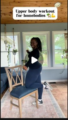 a woman standing on top of a chair in front of a window with the caption upper body workout for homebodies