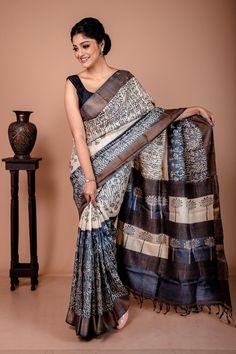 Grey and white is always an iconic combination. The entire saree is inspired by nature. It's the representation of grassland during the day and in night. The identity of the day is created by a black block print on the tussar colour and the identity of the night is created by a discharge block print on black dye colour. This zari border tussar saree with an extremely detailed and beautiful floral jaal block printing is a perfect evening wear saree. This zari saree is silk mark certified. Hence, you don't need to worry about the quality of the saree. It's absolutely top-notch. Grey is a classy colour While everyone is obsessed with bright colours such as red & blue, you can take a detour by choosing grey. The grey colour makes you look edgy and smart. Grey denotes class and sophistication. Copper Zari Saree, Tussar Saree, Zari Saree, Saree Silk, Ethnic Looks, Wear Saree