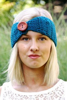 a woman with blonde hair wearing a blue headband and a button in the middle