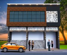 three people standing in front of a two story building with garage doors on each side