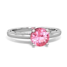 This milgrain 14K White Gold ring features a {shape} vibrant pink lab pink sapphire. Filigree accents surrond the gem, and matching cutouts add a distinct flair to this elegant ring. Heirloom Pink Jewelry With Center Stone, Pink Birthstone Ring With Gemstone For Formal Occasions, Formal Pink Birthstone Ring With Gemstone, Pink Gemstone Birthstone Ring For Formal Occasions, Formal Pink Gemstone Birthstone Ring, Pink Round Heirloom Jewelry, Round Pink Sapphire Rings With Diamond Cut, Classic Pink Sapphire Ring For Formal Occasions, Heirloom Pink Ring With Center Stone