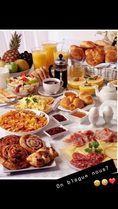 a table filled with lots of different types of food and drinks on top of it